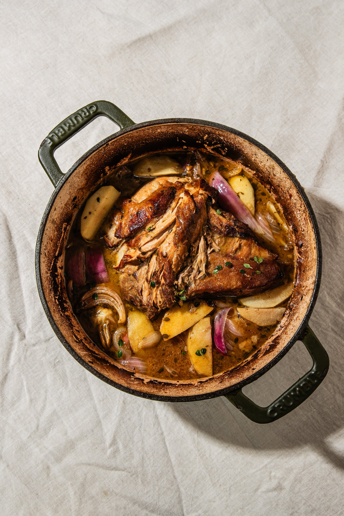 Cider-braised pork shoulder with apples and onions