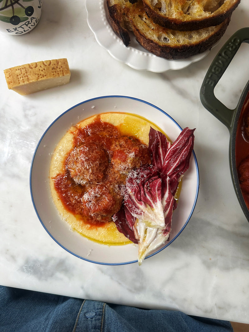 Giant meatballs poached in tomato sauce