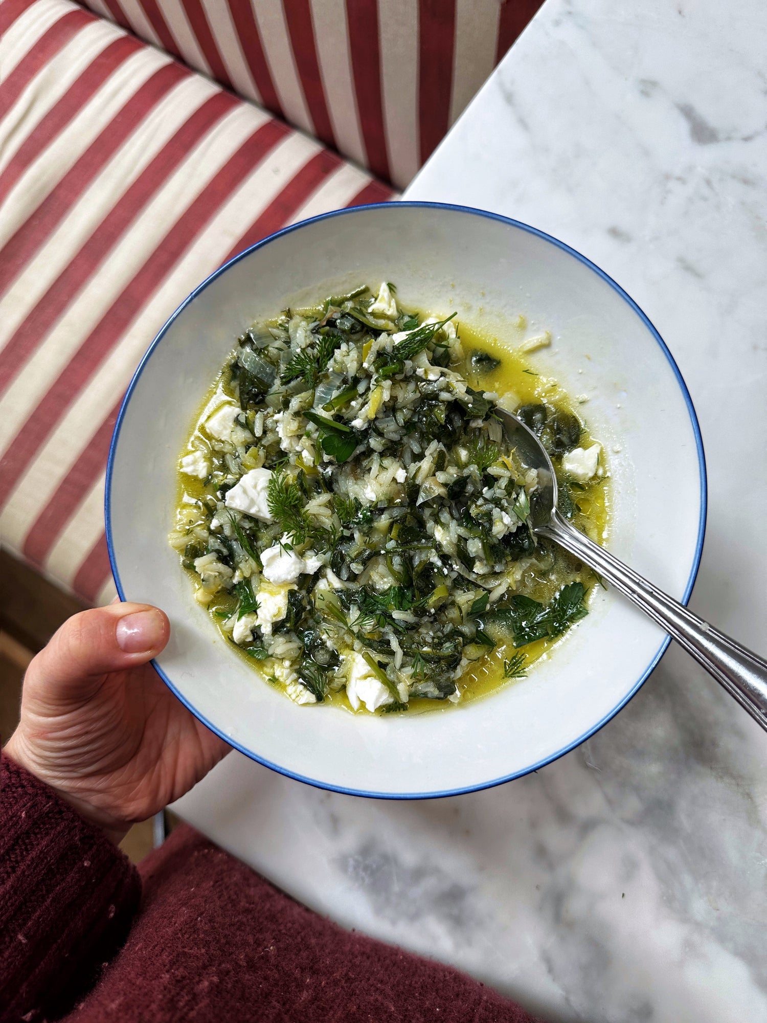 One pot, brothy green rice with olive oil, lemon and feta