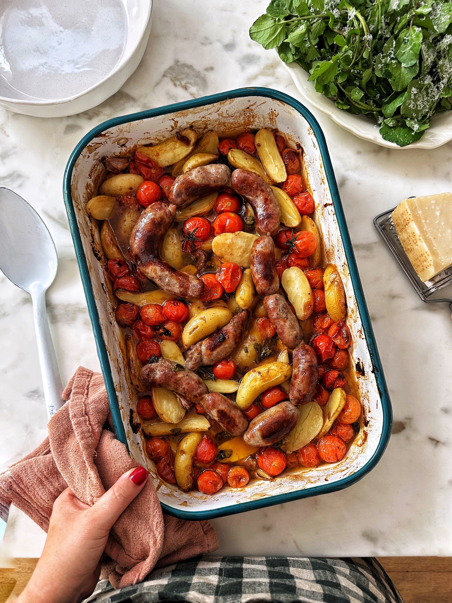 One tray sausage, potato, tomato and caramelised onion bake