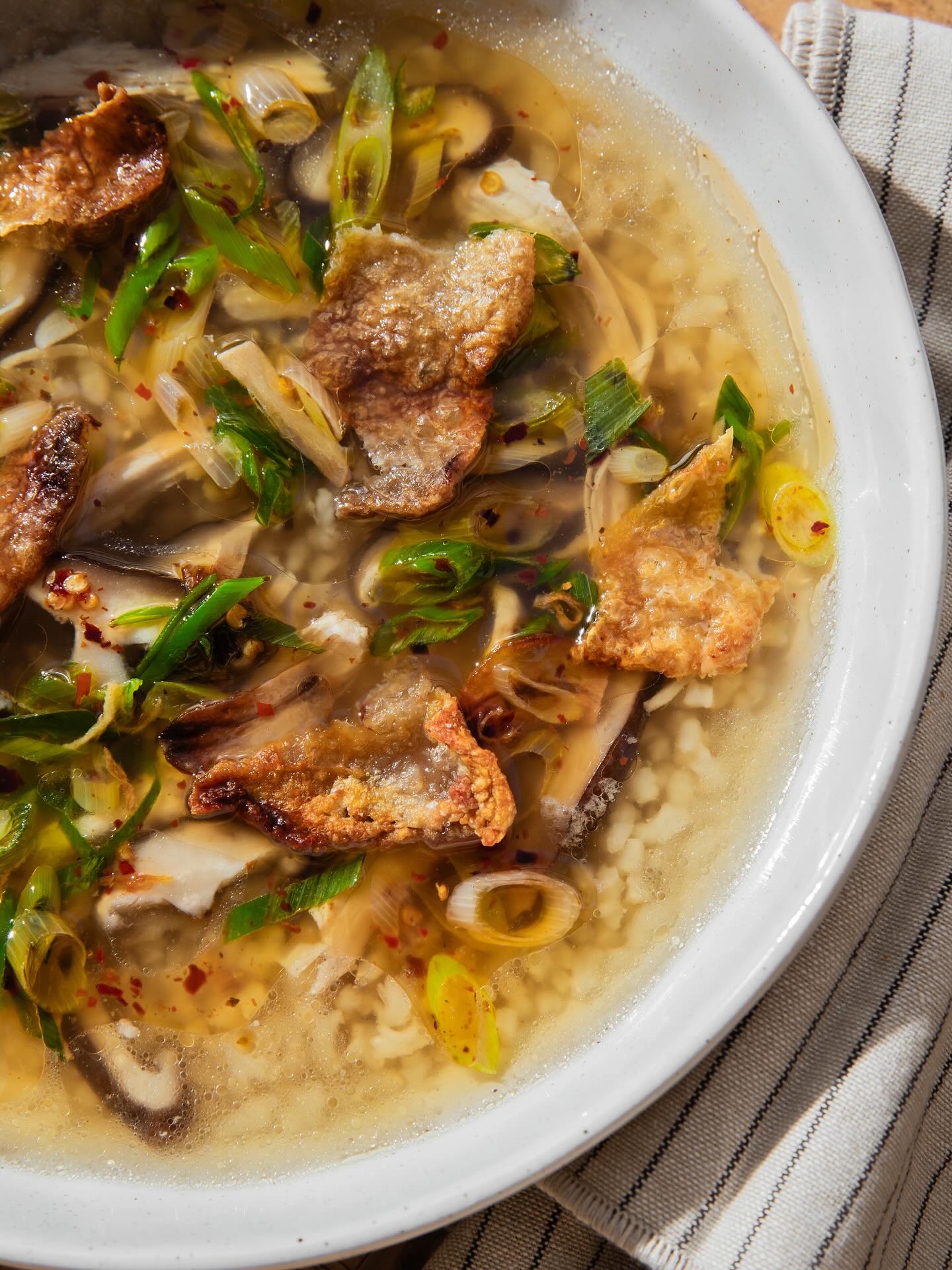 Congee chicken soup with crisped chicken skin and sizzling ginger-chilli-shallot sauce