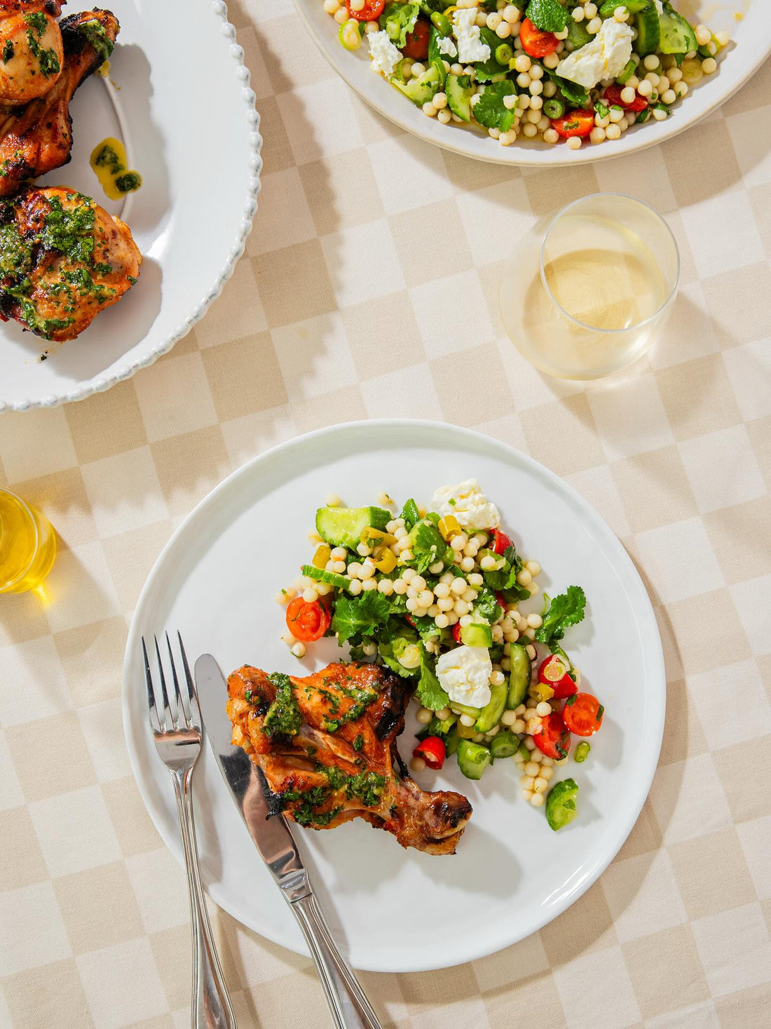 Butterflied chicken drumsticks with garlic, honey butter and a pearl couscous and pickled chilli salad