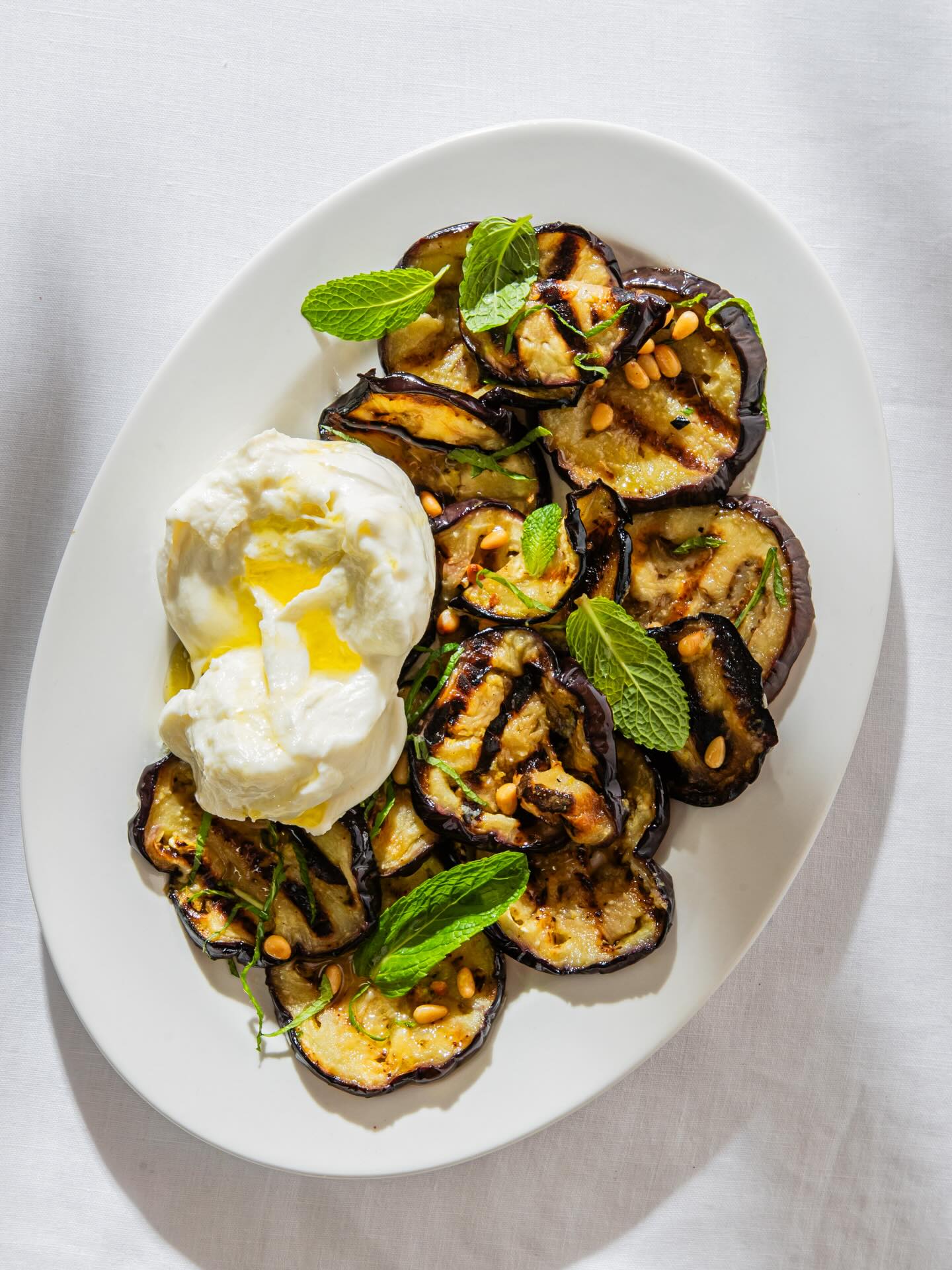 Grilled eggplant with mint, chilli, lemon and toasted pine nuts