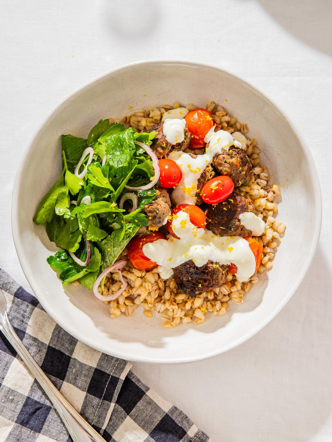 Salsa verde lamb patties and charred tomatoes on buglar wheat
